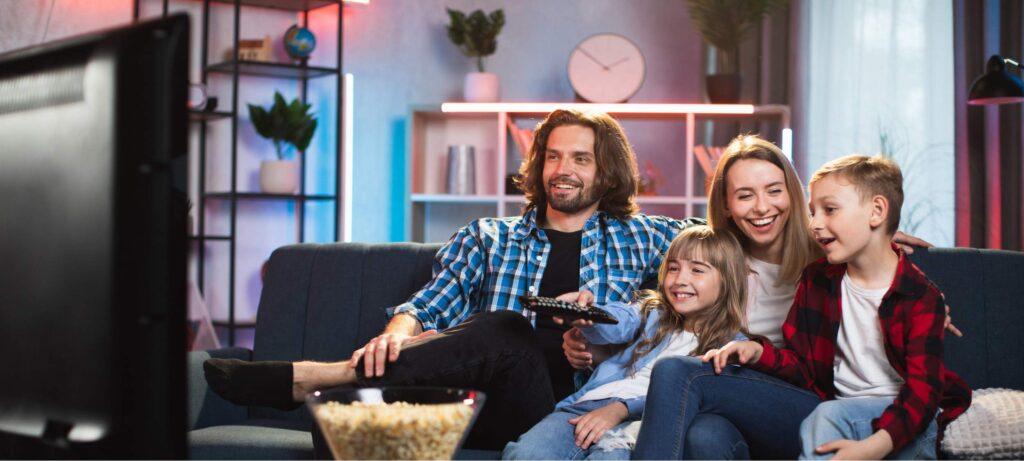 An image of a satisfied client and their family watching TV