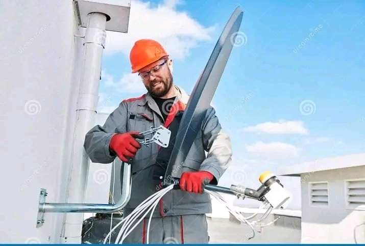 Image of the dstv stellite dish being mounted on a wall or roof